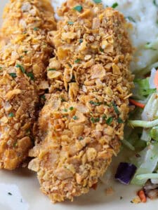 chicken breaded with cornflakes on plate with salad