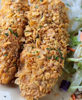 chicken breaded with cornflakes on plate with salad