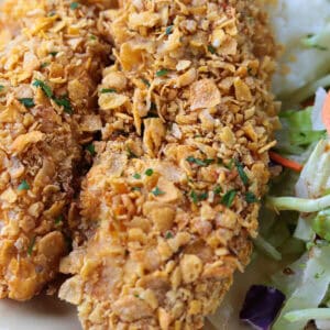 chicken breaded with cornflakes on plate with salad