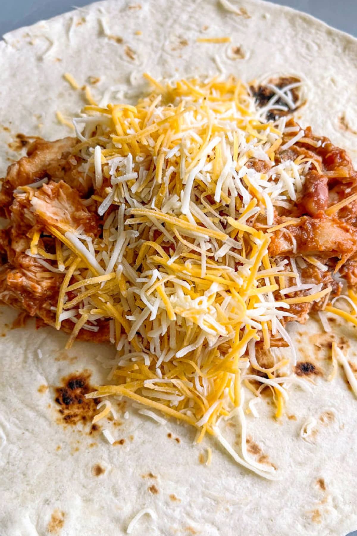 Chicken filling with cheese in a tortilla
