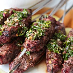 chimichurri sauce spooned over beef kabobs