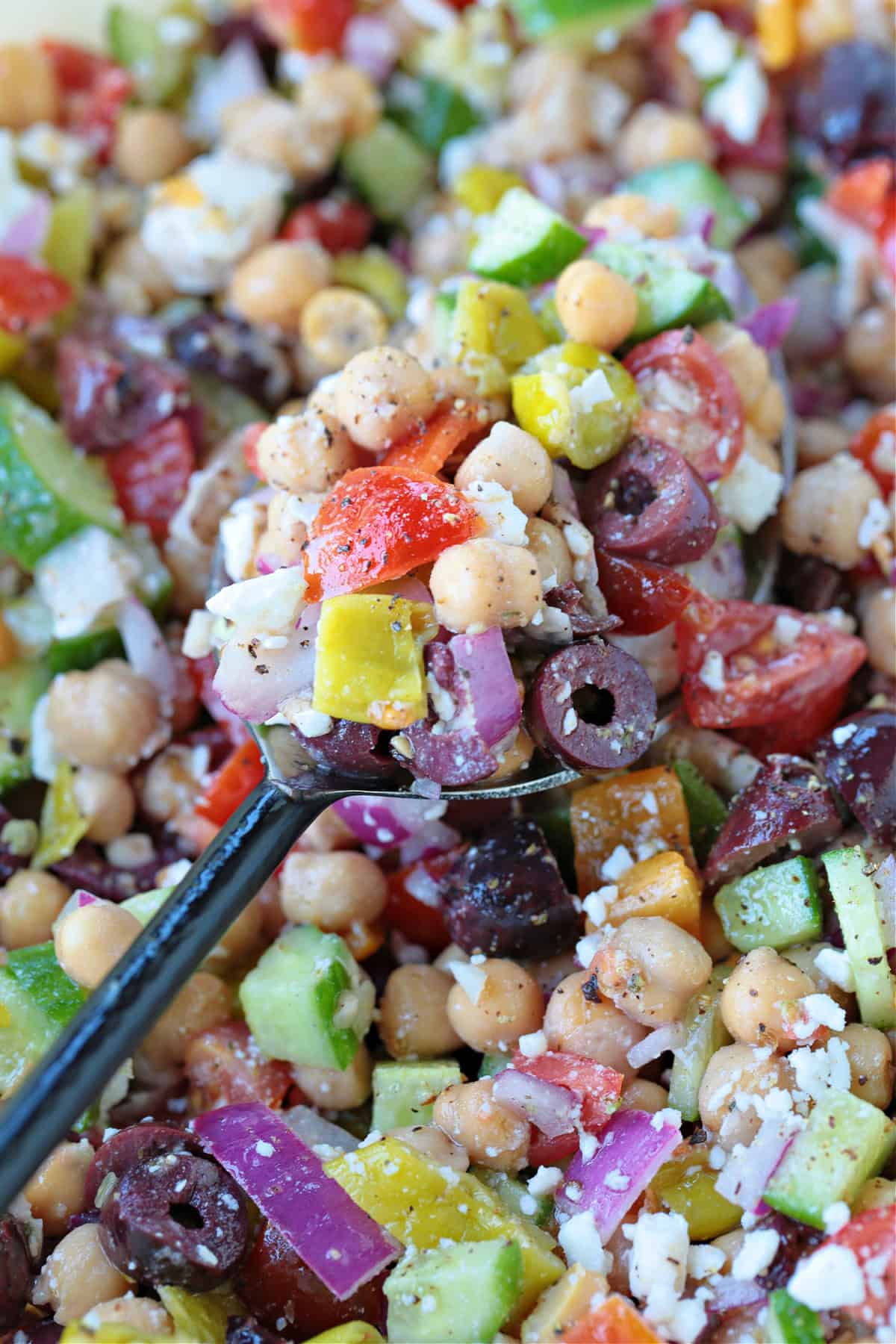 chickpea salad with greek flavors on spoon