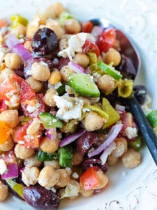 chickpea salad with vegetables and spoon on side
