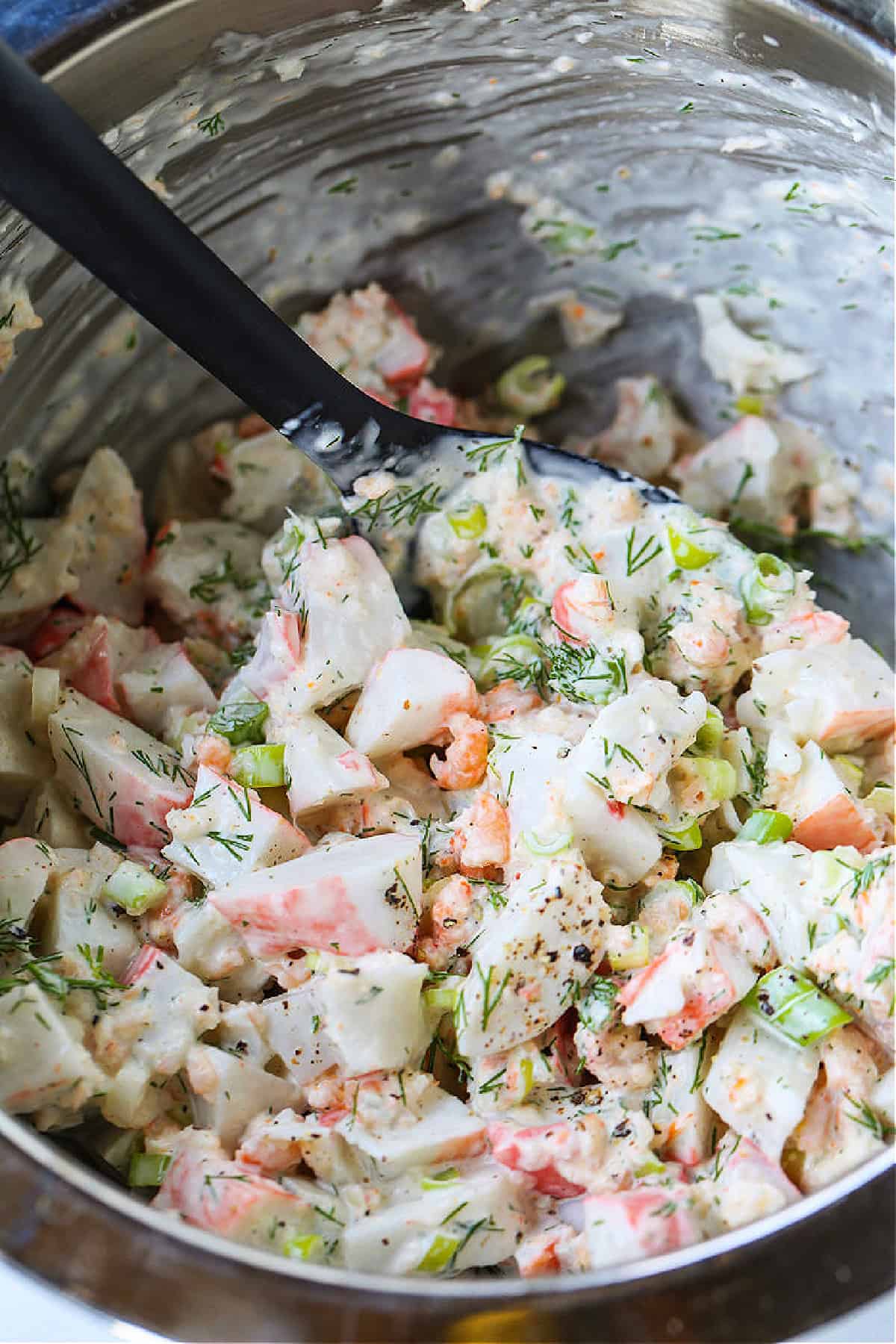seafood salad in bowl with spoon