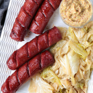 kielbasa links on a platter with cabbage