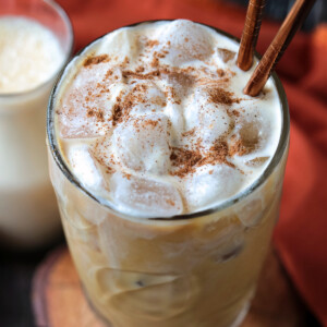 pumpkin cream cold brew in glass with spice on top and straws