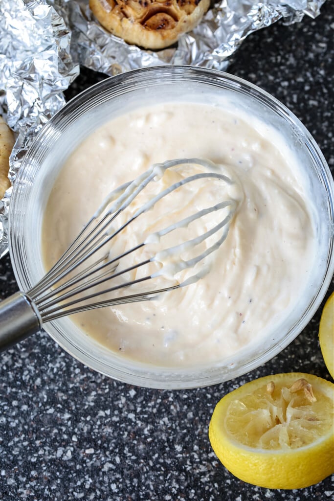 garlic aioli in a bowl with whisk