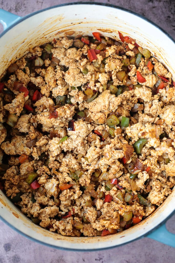 ground turkey, peppers and onions in a pot for chili recipe