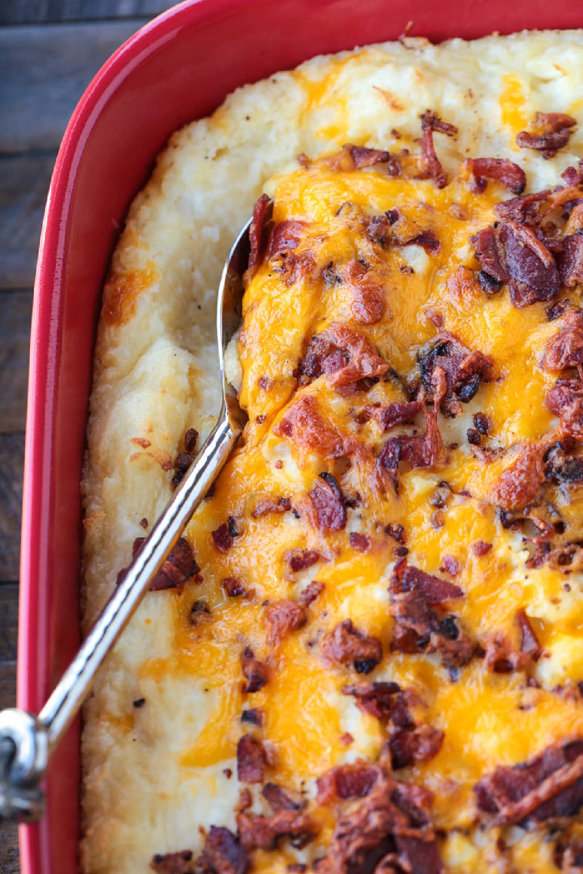 loaded mashed potato casserole with serving spoon