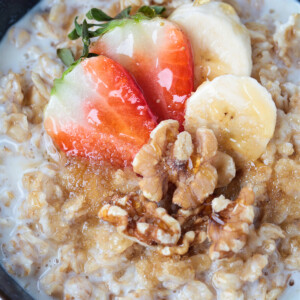 oatmeal in a bowl with strawberries, bananas and walnuts