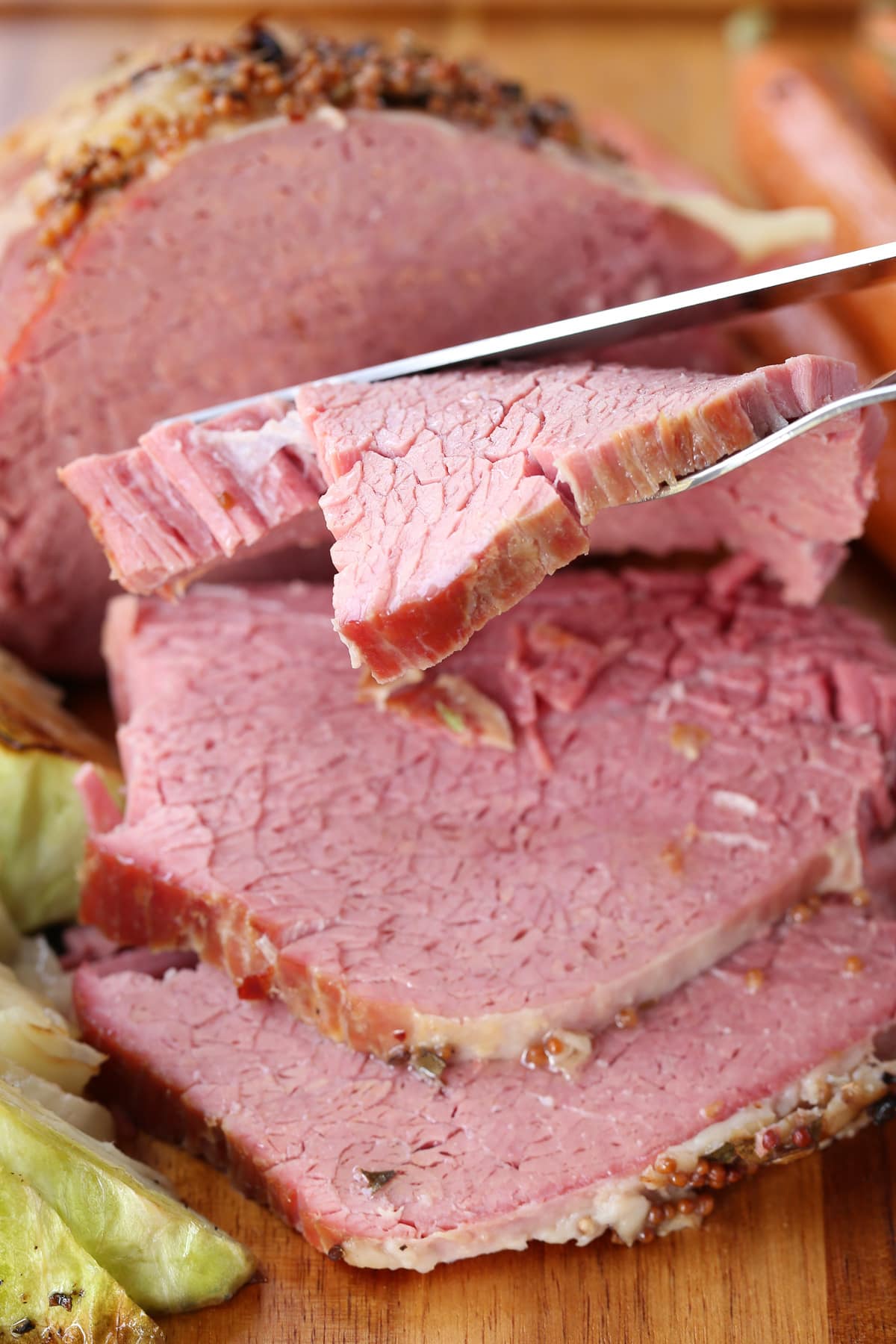 slice of corned beef with knife and fork