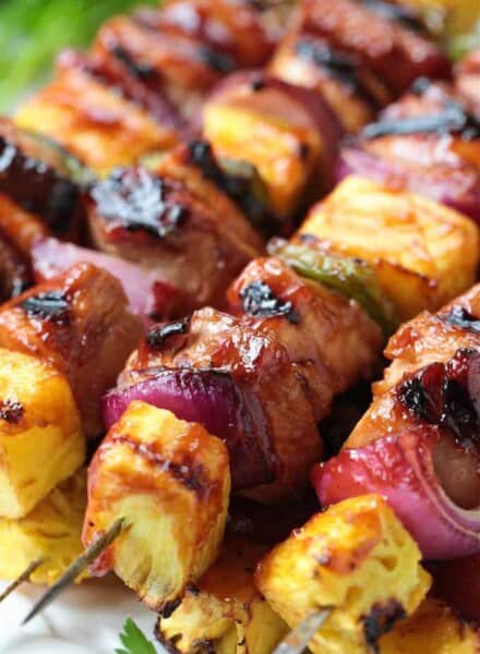 grilled chicken kabobs stacked on platter