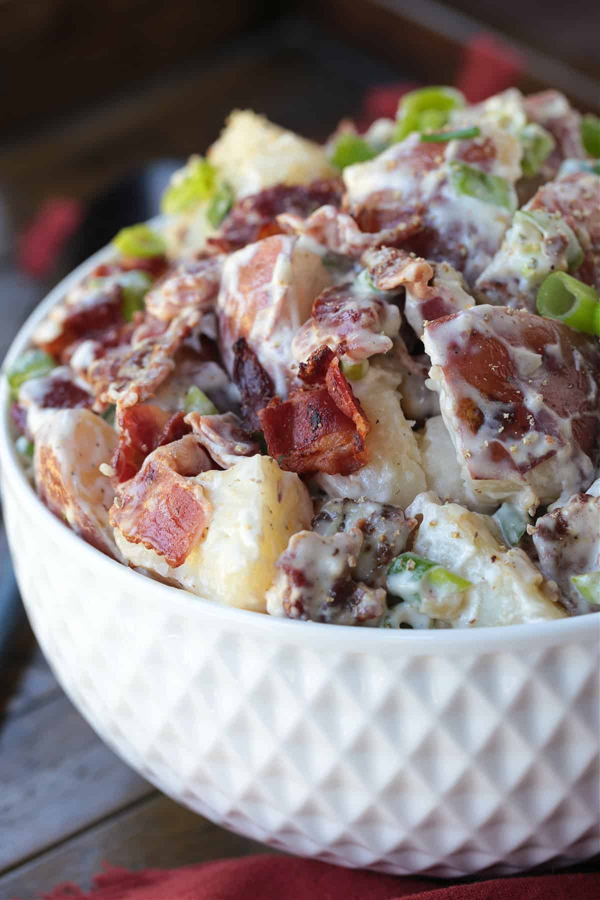 ranch potato salad in white bowl form the side