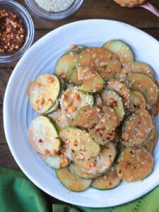 sliced cucumber salad in peanut sauce on plate