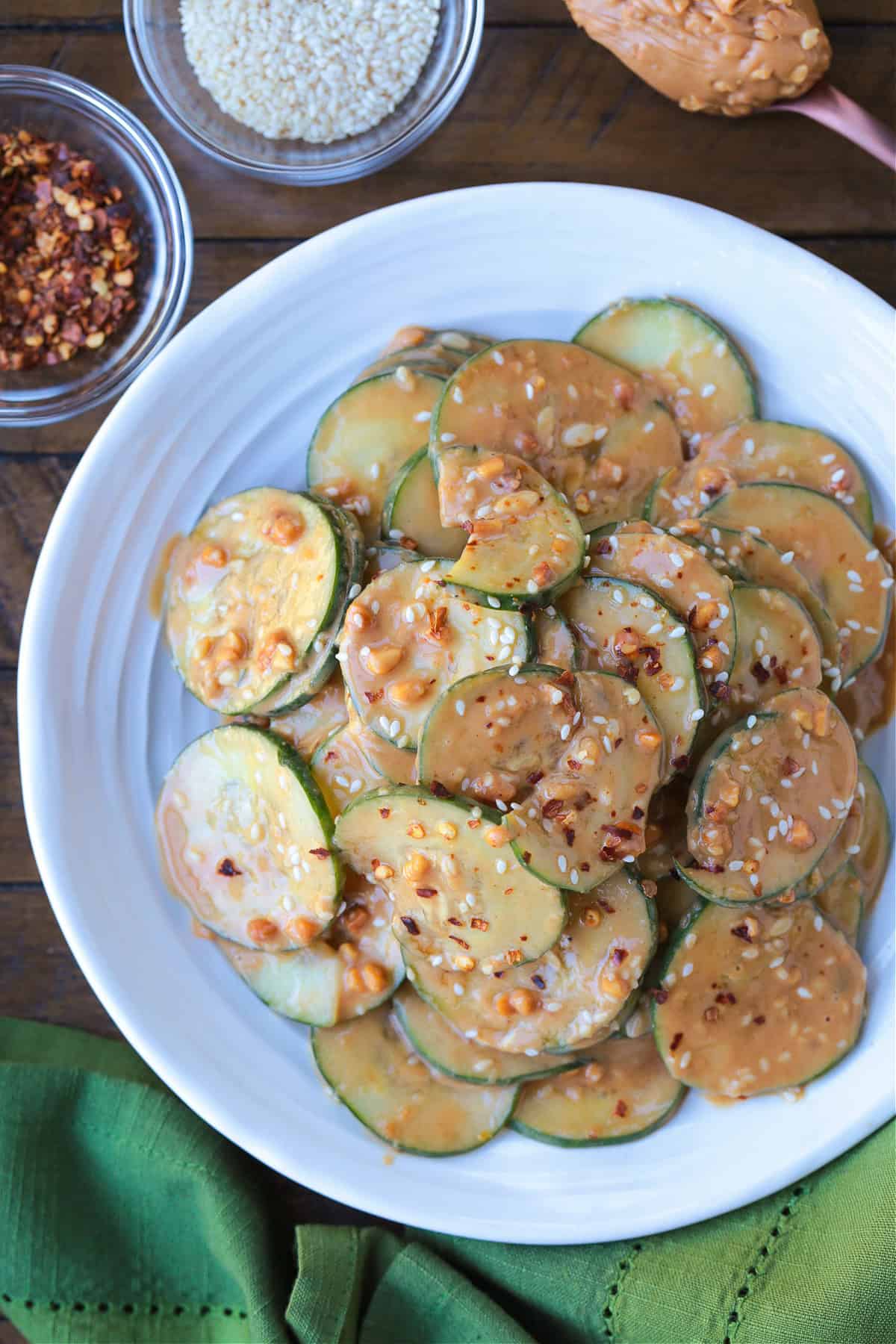 sliced cucumber salad in peanut sauce on plate