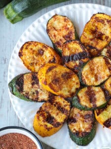 grilled slices of zucchini and yellow squash on white plate