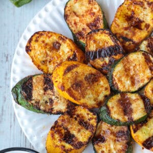 grilled slices of zucchini and yellow squash on white plate