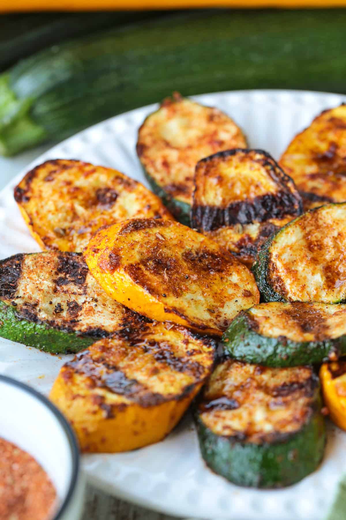 grilled slices of zucchini and squash stacked on plate