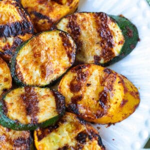 grilled zucchini and squash layered on white plate