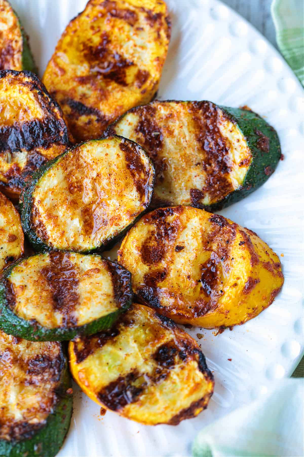 grilled zucchini and squash layered on white plate