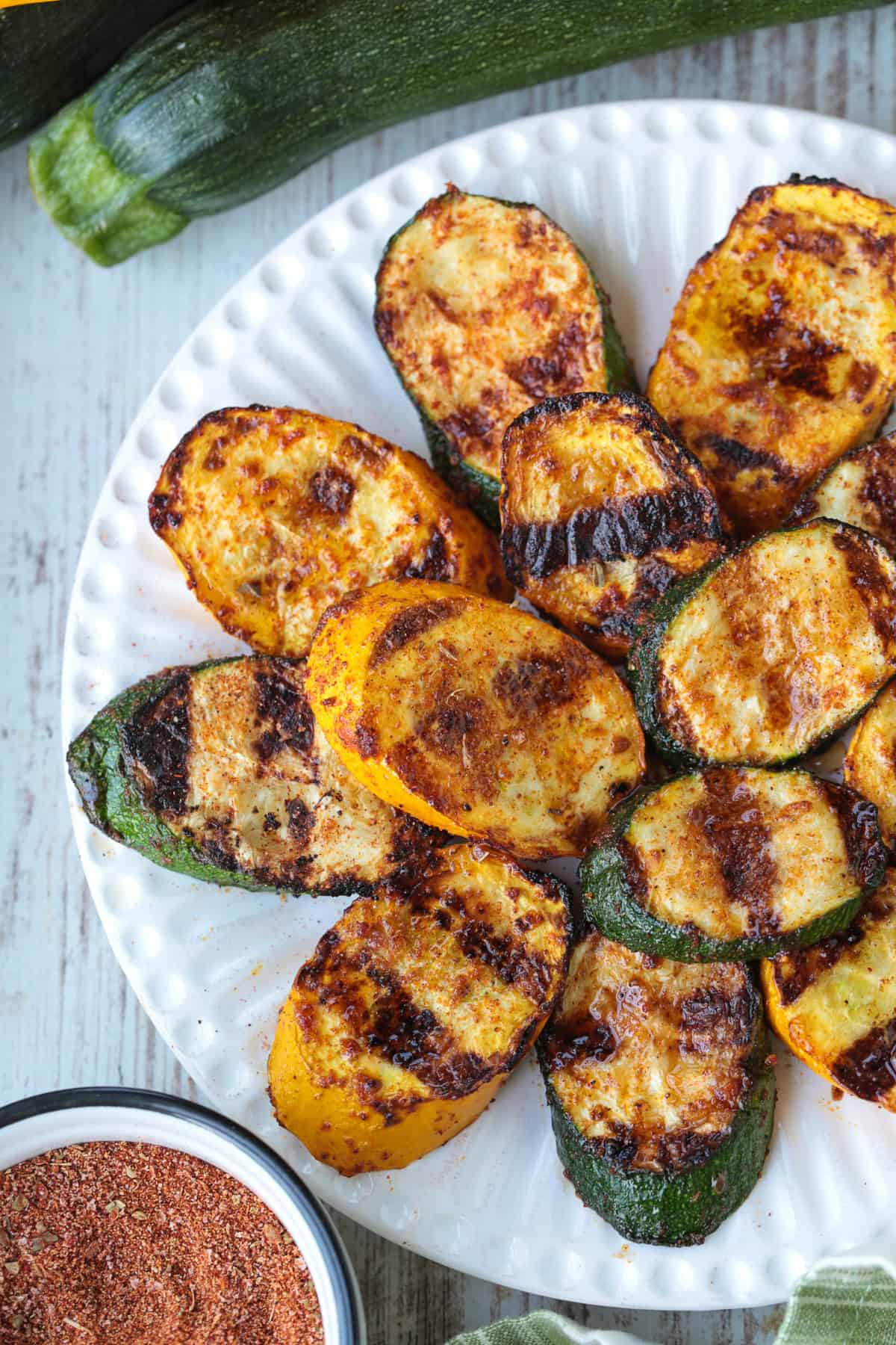 grilled slices of zucchini and yellow squash on white plate