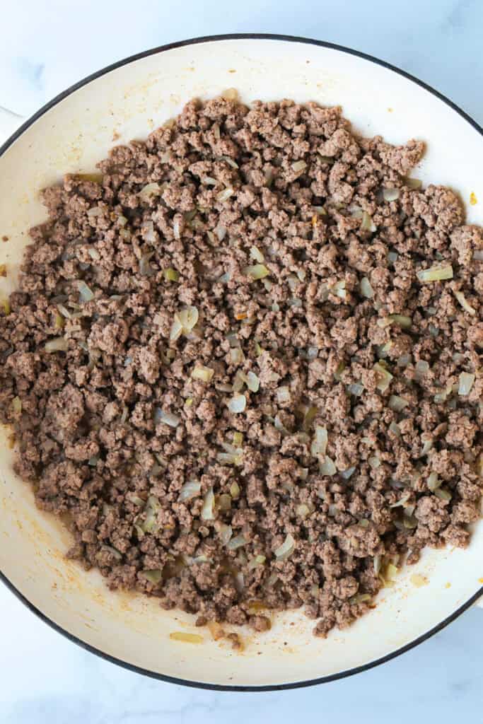 ground beef cooked in a skillet with onions