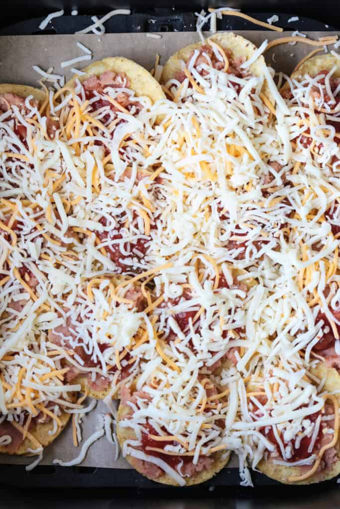 chips in air fryer and topped with cheese