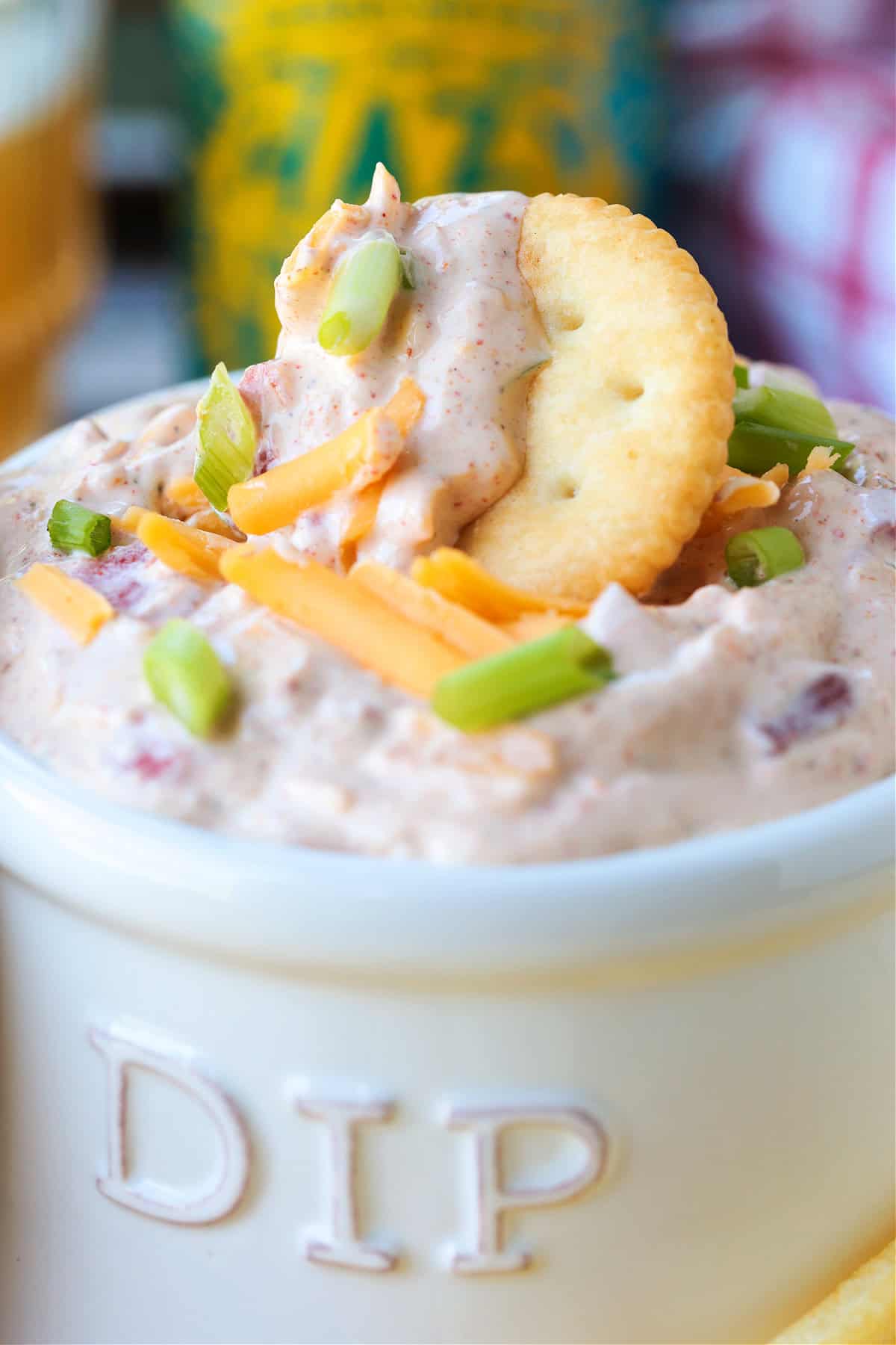 cracker dipping into sour cream dip