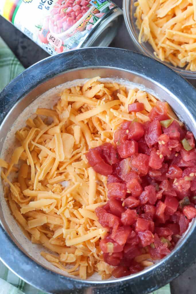 bowl with shredded cheese and rotel for making dip