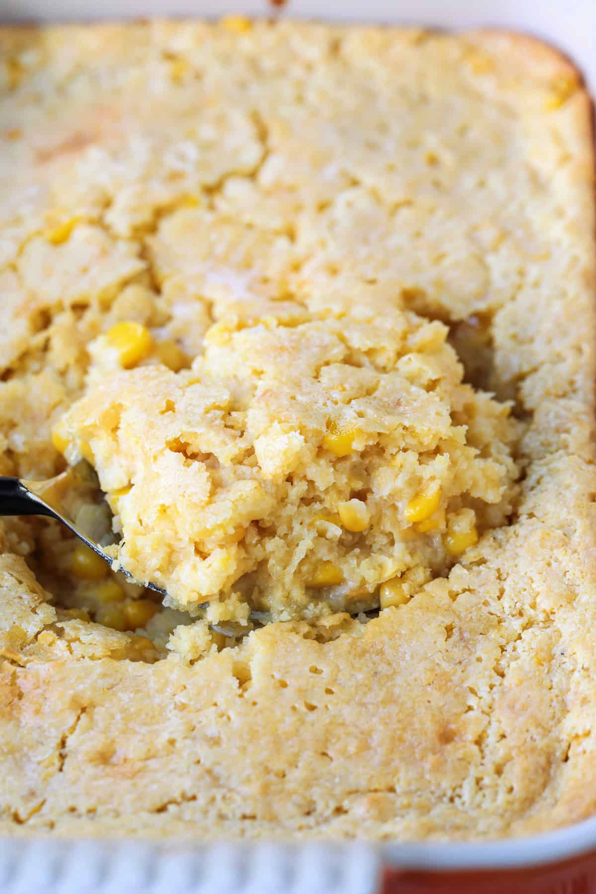 spoon scooping into corn casserole