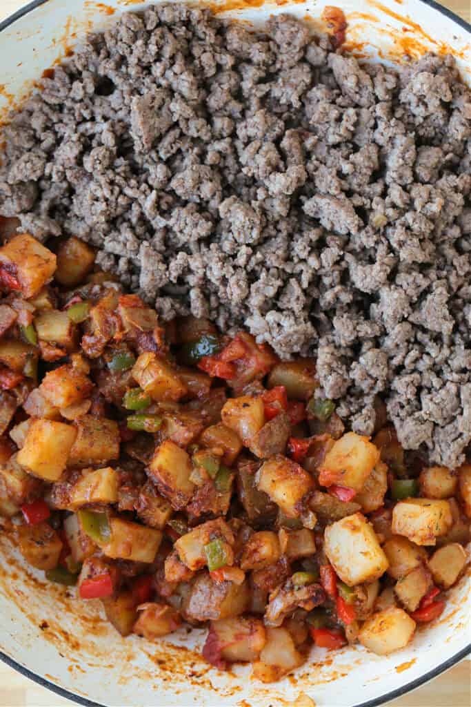 ground beef in skillet ith potatoes and vegetables on one side