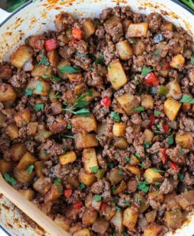 ground beef with potatoes and peppers in a skillet