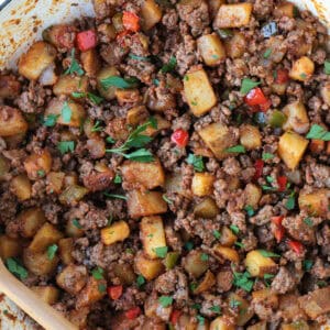 ground beef with potatoes and peppers in a skillet