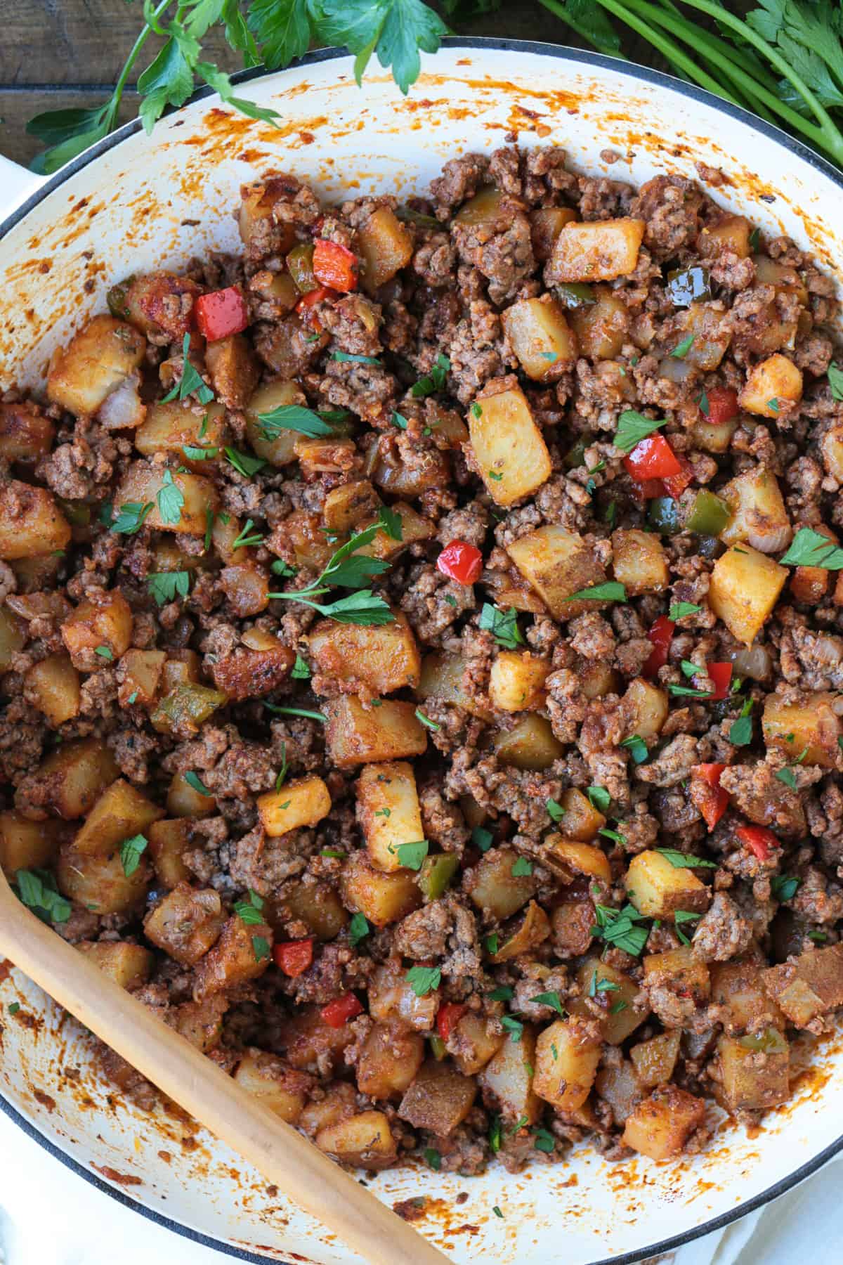 ground beef with potatoes and peppers in a skillet