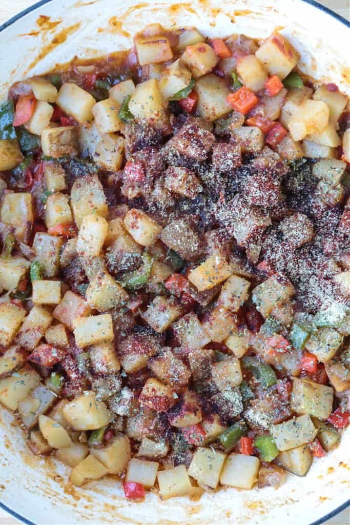 seasoned potatoes and peppers in a skillet