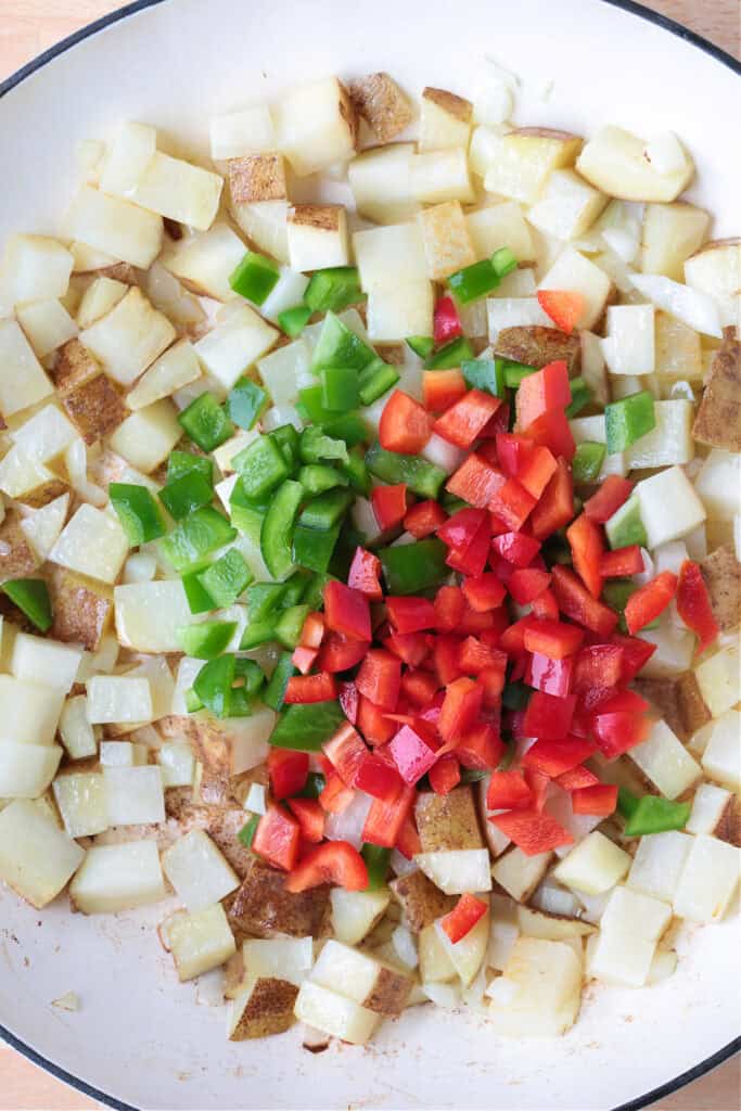 diced potatoes and peppers in a skillet