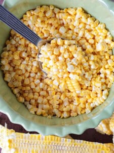 bowl of corn kernels with large spoon