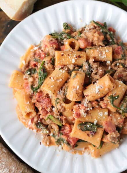 rigatoni with sausage in a pink cream sauce on a white plate