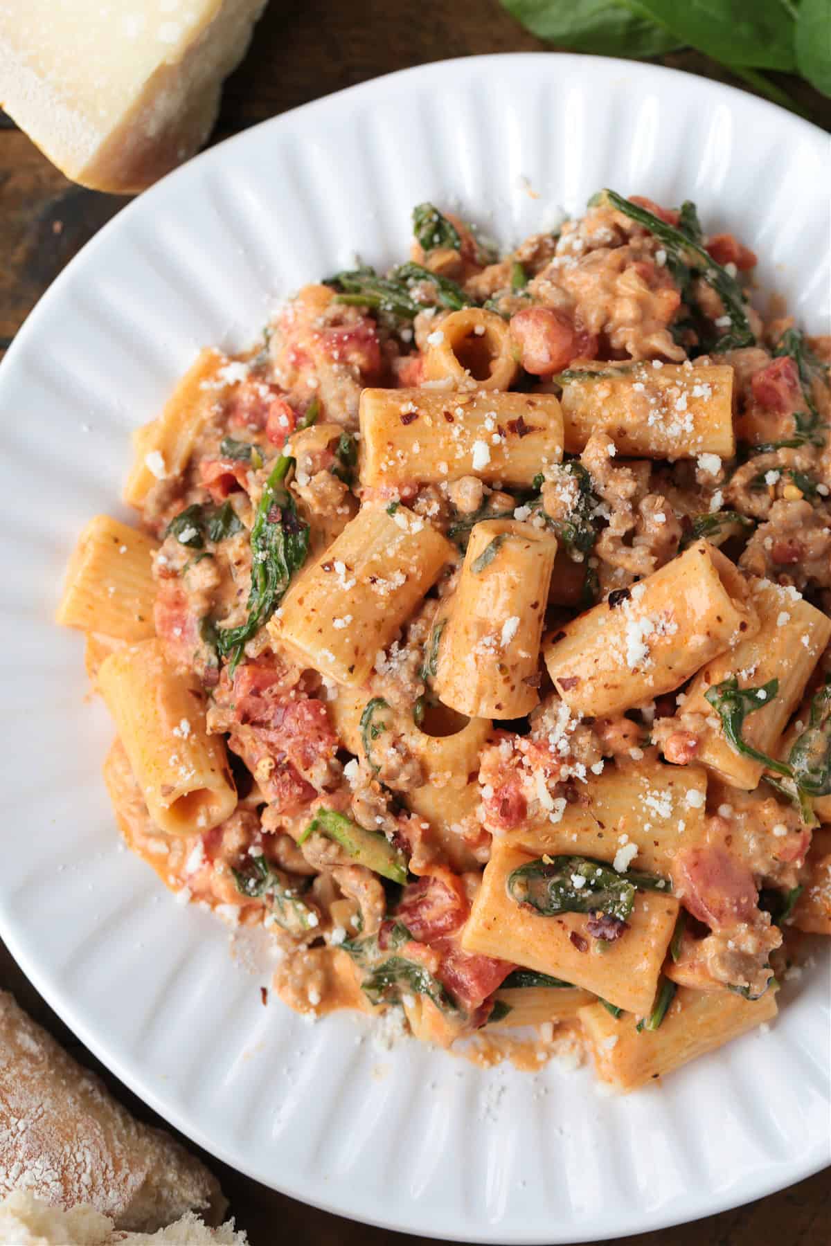 rigatoni with sausage in a pink cream sauce on a white plate