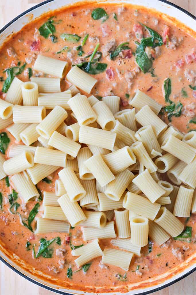 rigatoni in a skillet with pink cream sauce