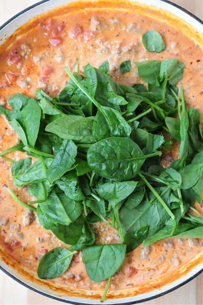 fresh spinach in a skillet with cream sauce