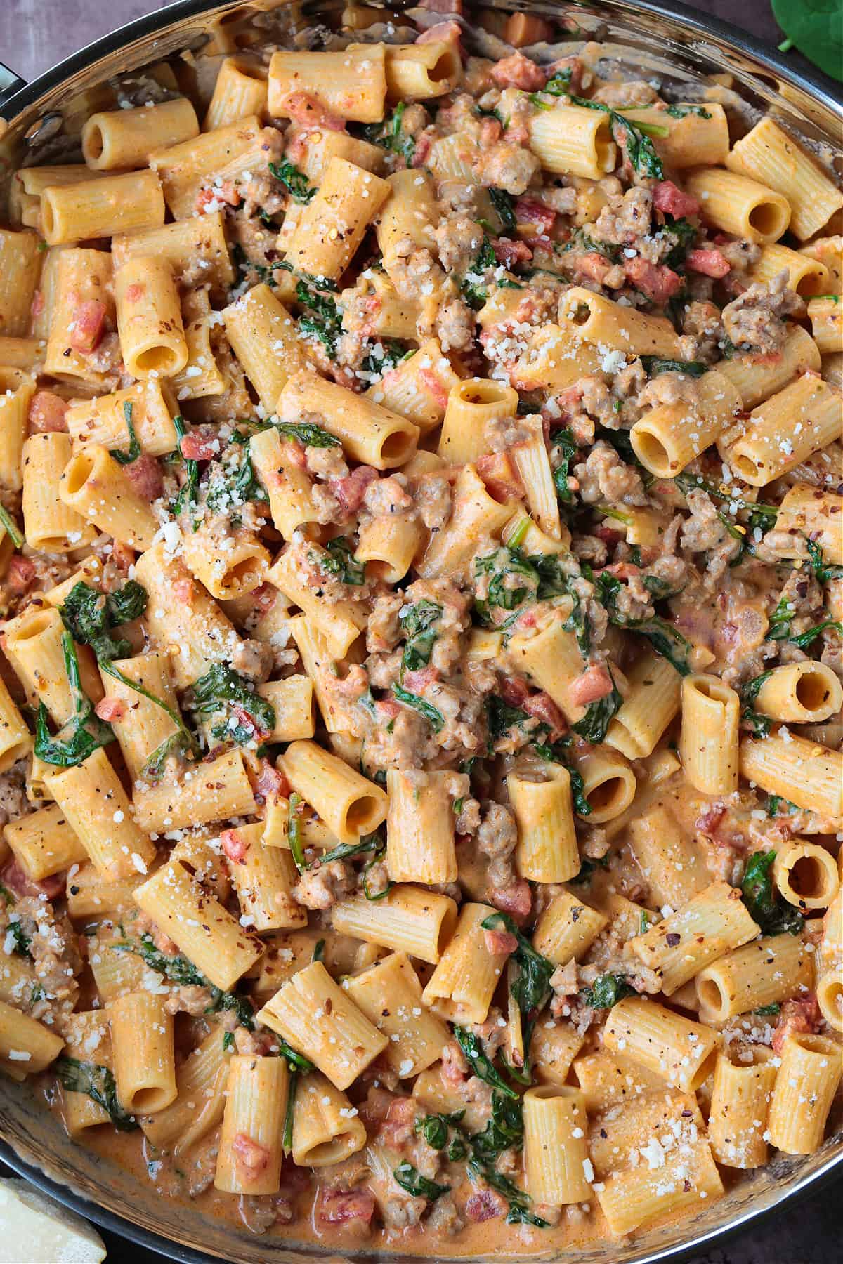 rigatoni with sausage and spinach in a large skillet