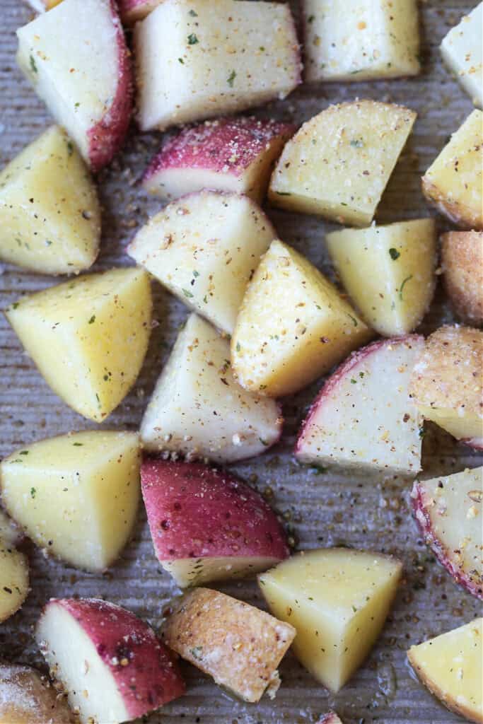 diced potatoes with ranch seasoning on baking sheet