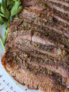 close up of sliced steak on platter