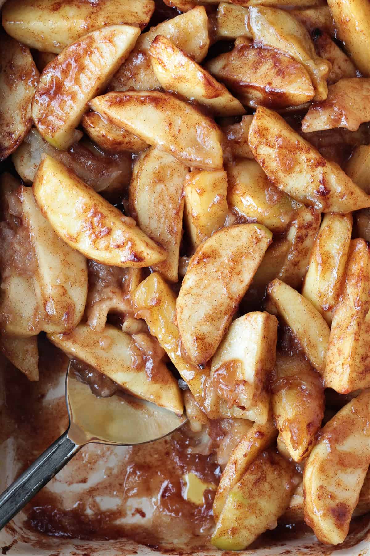 baked apple slices with serving spoon