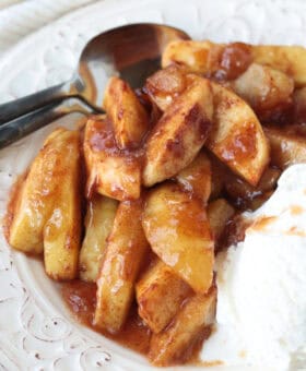 baked apples in syrup with ice cream on the side