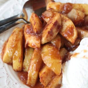 baked apples in syrup with ice cream on the side