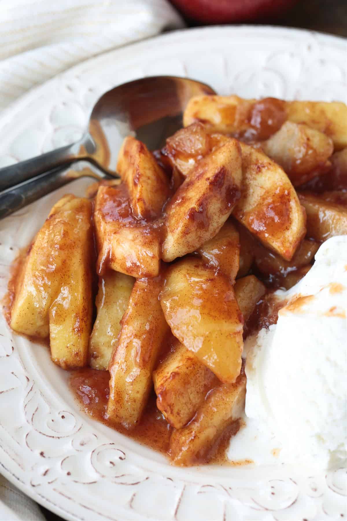 baked apples in syrup with ice cream on the side