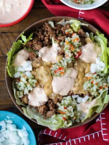 cheeseburger bowl with napkin and toppings on the side