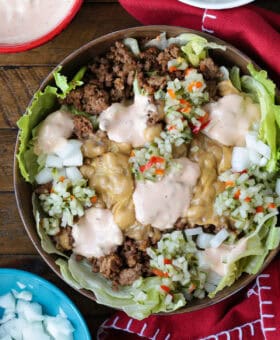 cheeseburger bowl with napkin and toppings on the side